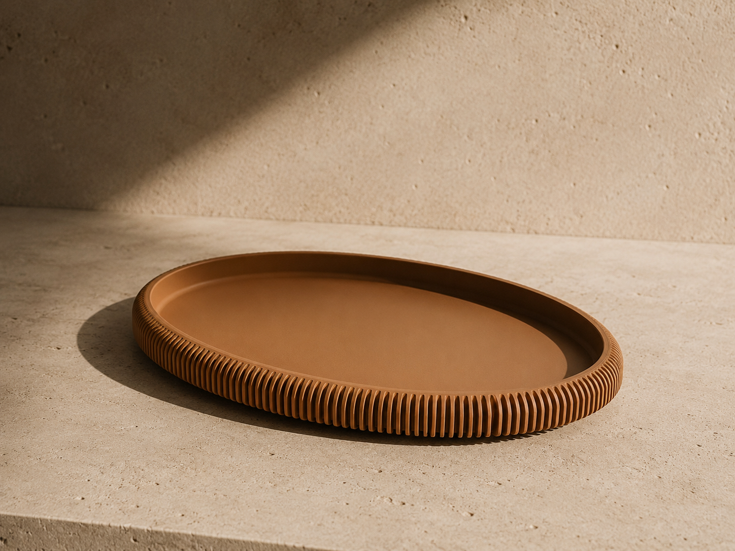 Lago oval tray holding everyday objects on a warm surface.